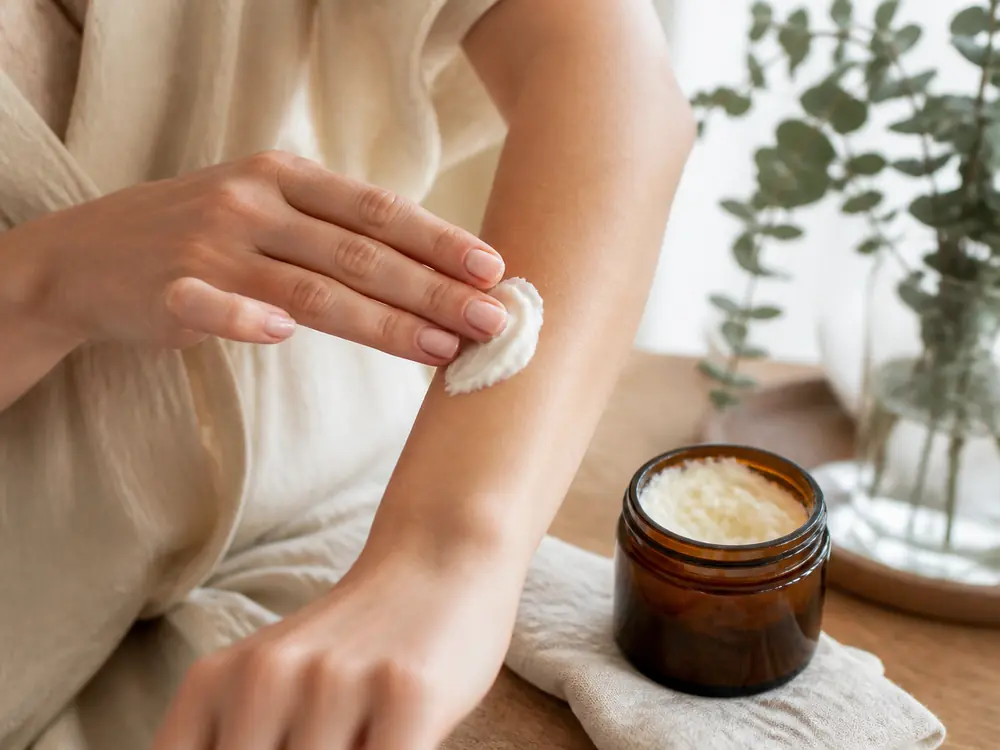 Applying handmade whipped body butter to the skin